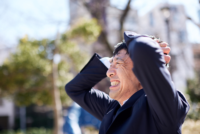 Japanese businessman suffering from headaches