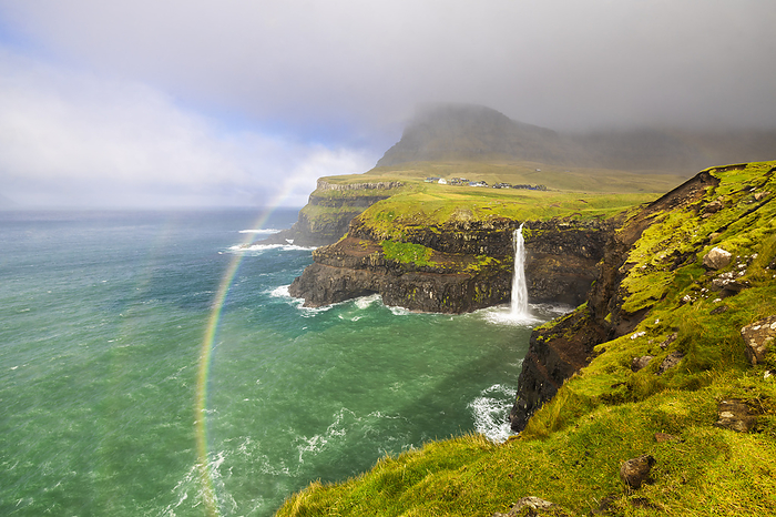 Faroe Islands Mulafossur waterfall and Arnafjall and Heinanova mountains with rainbow, Gasadalur, Vagar, Faroe Islands, Denmark, Scandinavia