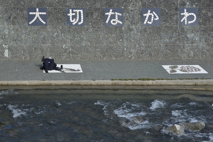  Typhoon No. 26, fatal accident in Sakai River Familiar rivers sometimes pose a threat October 17th, 2013 : Kanagawa, Japan   A man lies down and reads a book at Sakai River, which separates Tokyo and Kanagawa. A lot of people use the sidewalks to go to school or work or to exercise daily. Usually, it is a quiet river, but a flood caused by a huge typhoon two days ago killed a woman.  Photographed from Yamato, Kanagawa, Japan on October 17th, 2013 by Koichiro Suzuki AFLO 