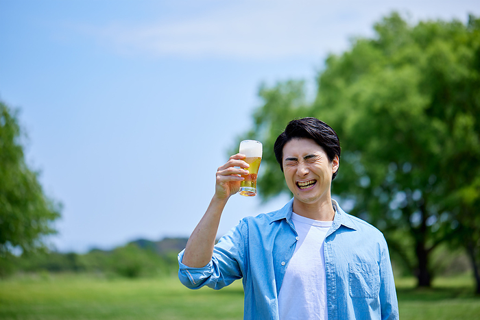 Japanese man drinking beer with fresh greenery