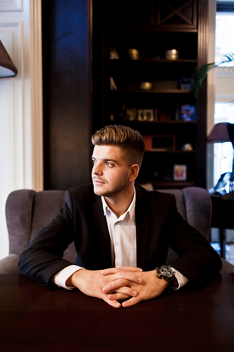 young stylish european man in a suit before a business meeting