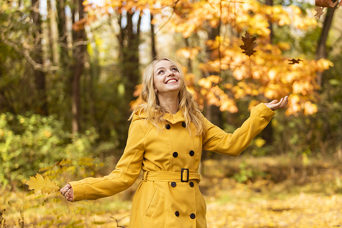 Happy woman enjoying in autumn park
