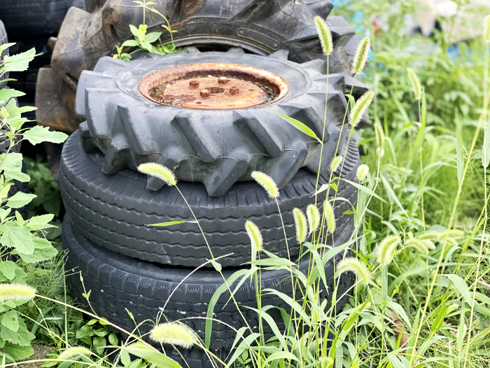 Old tires piled up on the grass