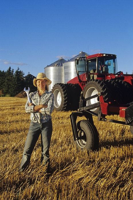 Farm Girl With Wrench, In Front Of A Tractor, Dugald, Manitoba