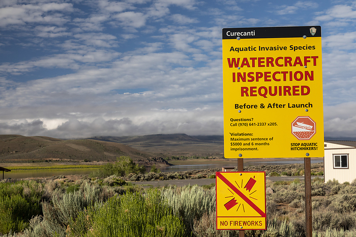 Watercraft inspection sign for invasive aquatic species Watercraft inspection sign for motorboats and sailboats to prevent invasive aquatic species entering Blue Mesa Reservoir, Colorado, USA. Colorado s mandatory inspection program aims to keep zebra mussels, quagga mussels, New Zealand mudsnails, Eurasian watermilfoil, Asian carp, and rusty crayfish out of the state s waters. Photographed at Curecanti National Recreation Area, Colorado, USA., by JIM WEST SCIENCE PHOTO LIBRARY