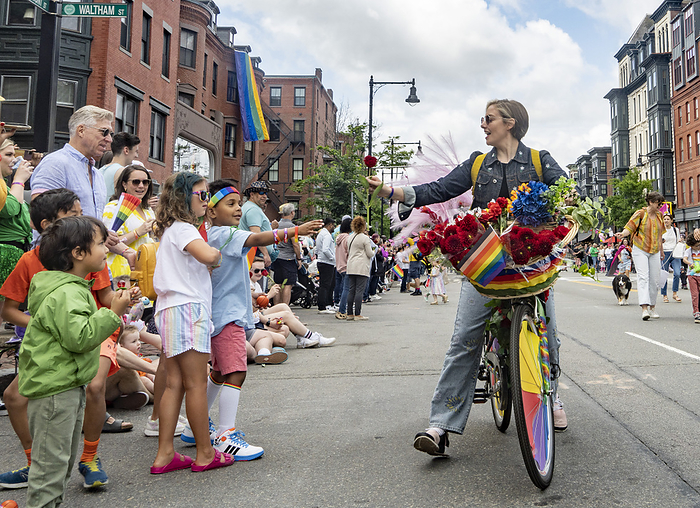 Pride Parade in Boston, U.S.A. June 10, 2023, Boston, Massachusetts, USA: A march goer hands out a rose to the audience during the inaugural Boston Pride for the People parade downtown Boston, Massachusetts.  Photo by Keiko Hiromi AFLO   