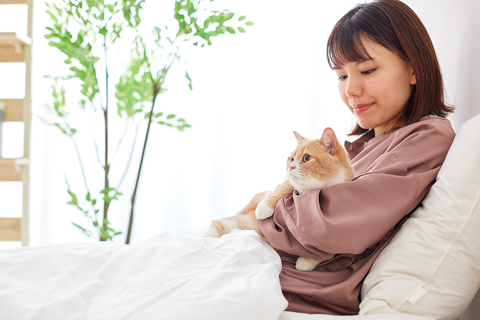 Cat being held by Japanese woman