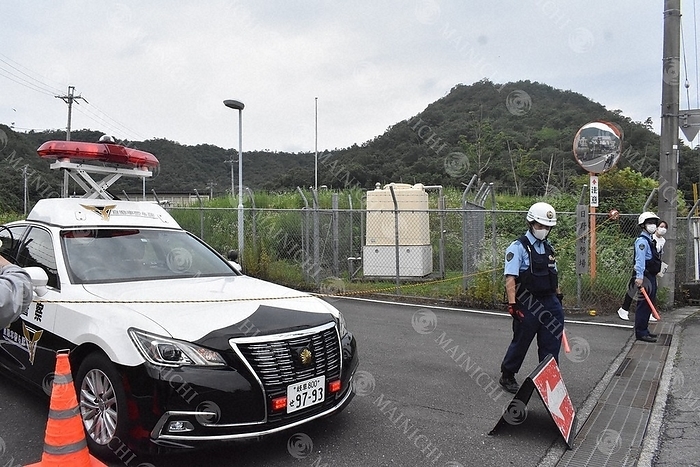 Police officers stand guard in front of the gate of the Hino Basic Firing Range of the Japan Ground Self Defense Force, where the shooting took place. Police officers stand guard in front of the gate of the JGSDF Hino Basic Firing Range, where the shooting took place, in Hino Minami, Gifu City at 11:13 a.m. on June 14, 2023.