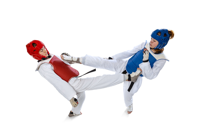 Top view of two young women, taekwondo athletes training together isolated over white background. Concept of sport, skills Korean martial arts. Top view of two young women, taekwondo athletes training together isolated over white background. Challenges. Concept of sport, education, skills, workout, health