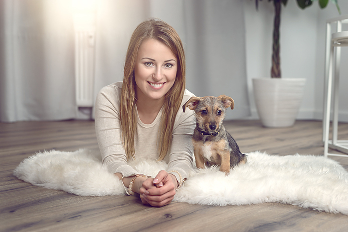 Attractive friendly woman with her dog Attractive friendly woman with her dog, by Zoonar Lars Zahner
