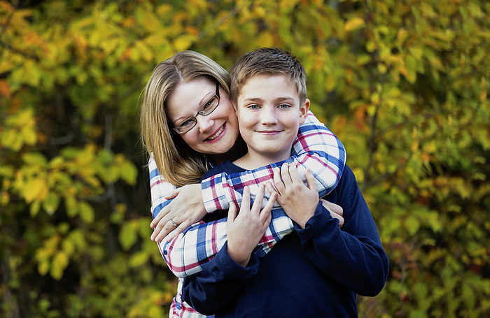 Outdoor portrait of a mother with her son in an embrace; Edmonton, Alberta, Canada, by LJM Photo / Design Pics