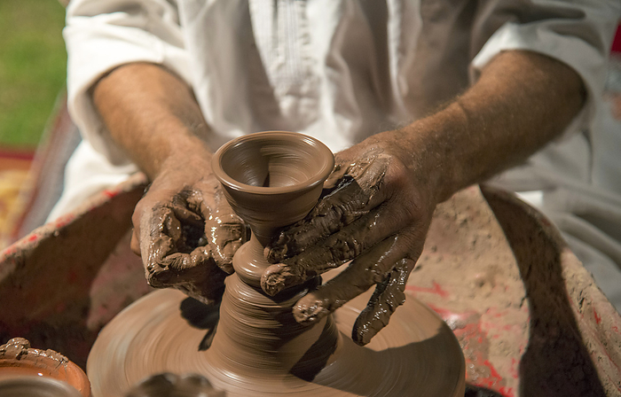 Oman Traditional potter at work  Muscat, Oman, by Michael Melford   Design Pics