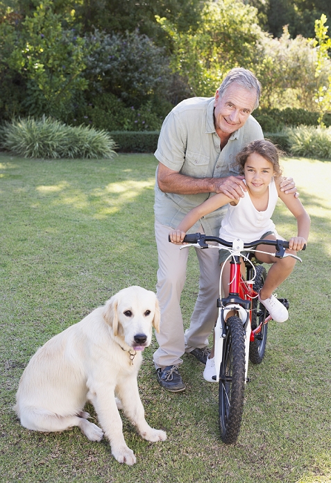Older man with granddaughter and dog