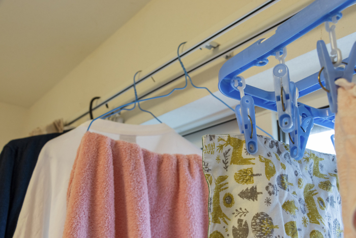 Laundry hanging on the curtain rail by the window