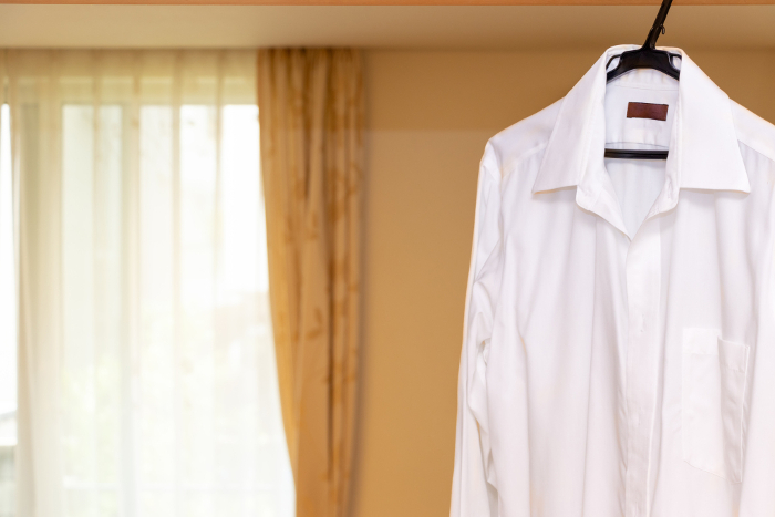 White shirt hanging in a bright room