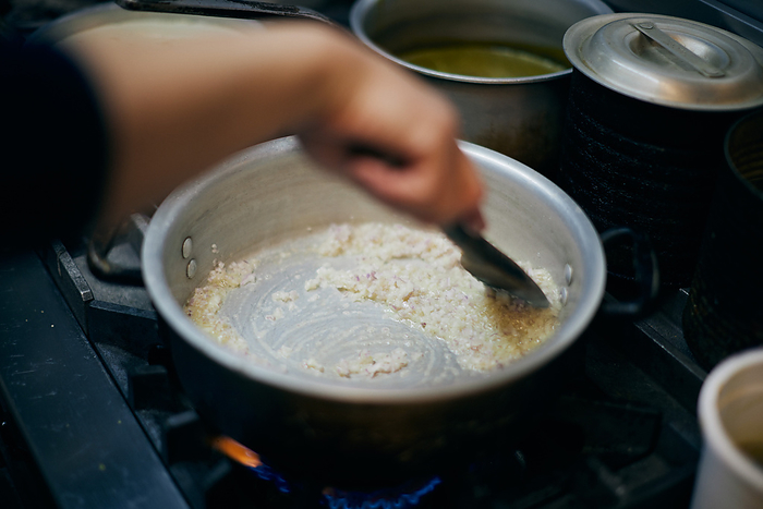 Chef's hands preparing risotto