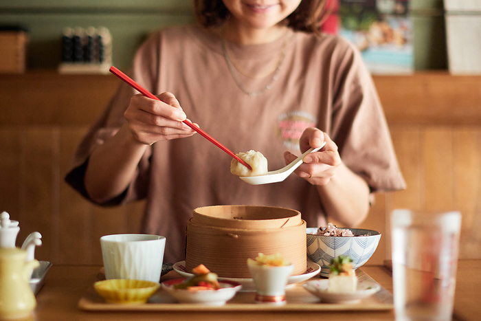 Japanese woman eating dim sum