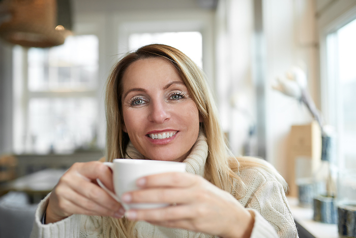 Beautiful woman relaxing at home with coffee Beautiful woman relaxing at home with coffee, by Zoonar Lars Zahner L