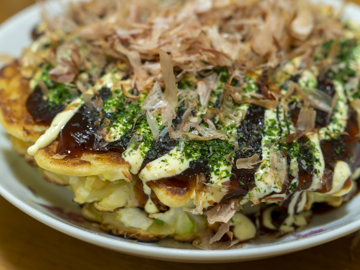 Okonomiyaki topped with green laver and dried bonito flakes