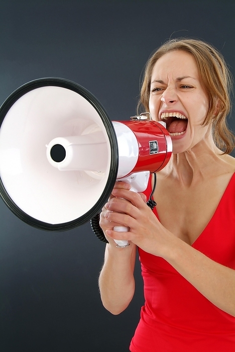 Young woman screaming in a megaphone, by Michaela Begsteiger