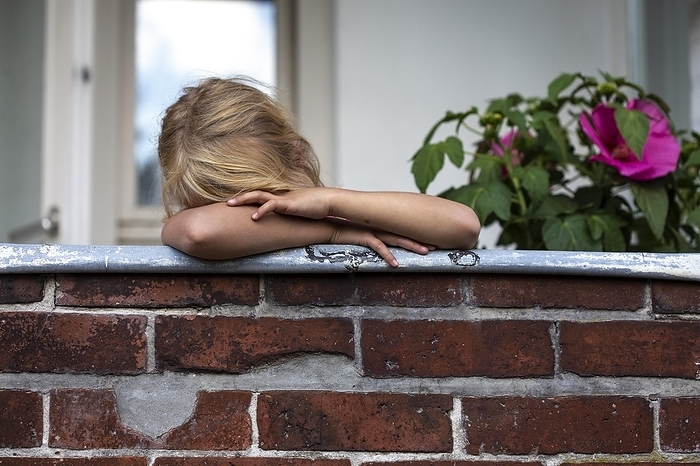Girl (8) sad on balcony, Kiel, Schleswig-Holstein, Germany, Europe, by alimdi / Jana Fernow