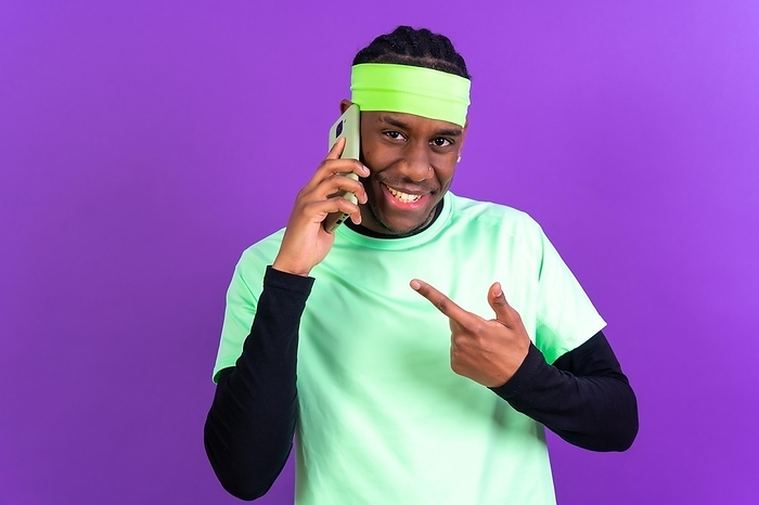 Black ethnic man with a phone in green clothes isolated over purple background, talking on the phone, by Unai Huizi