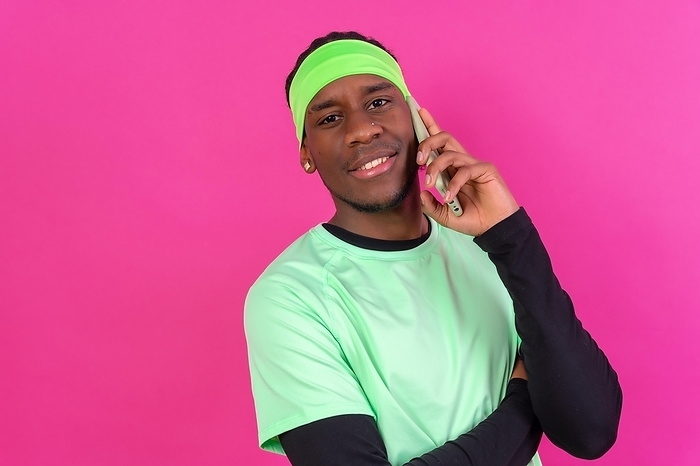 Black ethnic man with a phone in green clothes on a pink background, smiling talking on the phone, by Unai Huizi