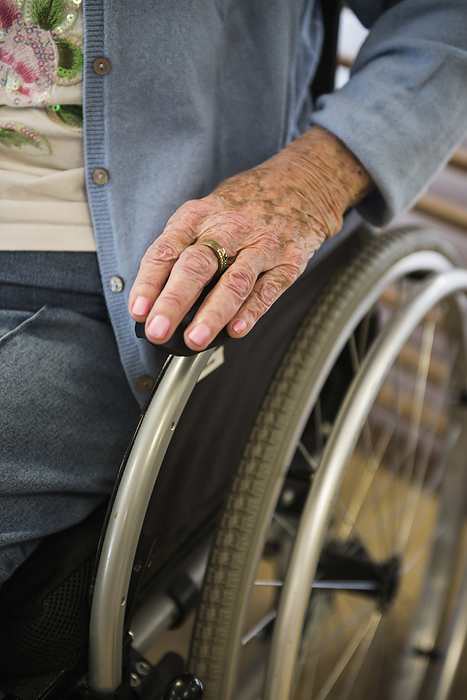Hand of a senior woman in a wheel chair, close up Senior woman in a wheelchair