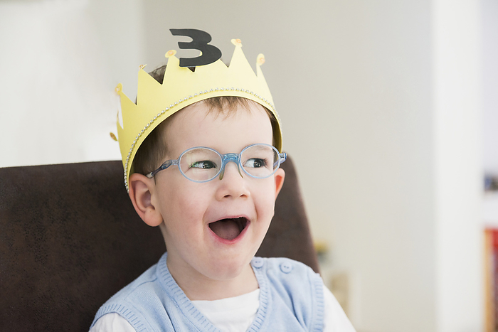 Happy little boy, birthday, crown, three years A happy boy wearing crown is surprised on his birthday, Bavaria, Germany