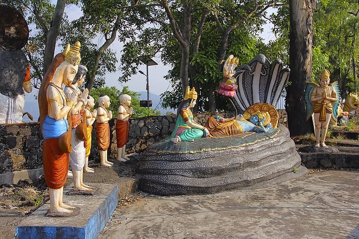 Statue of Lord Vishnu resting on Sheshnaag  snake , with wife Lakshmi sitting and Lord Brahma, Nilkantheshwar Temple Statue of Lord Vishnu resting on Sheshnaag  snake , with wife Lakshmi sitting and Lord Brahma, Nilkantheshwar Temple, by Zoonar RealityImages
