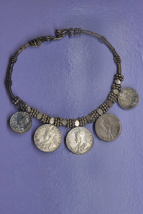 Ornamental necklace made from silver or white metal and currency coins Ornamental necklace made from silver or white metal and currency coins, by Zoonar RealityImages