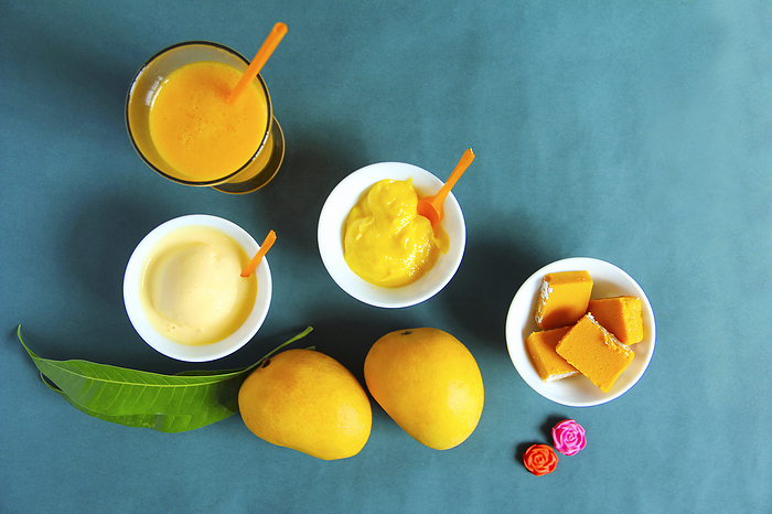 Top view showing alphonso mango and its by products like sweet, ice cream and shake Top view showing alphonso mango and its by products like sweet, ice cream and shake, by Zoonar RealityImages