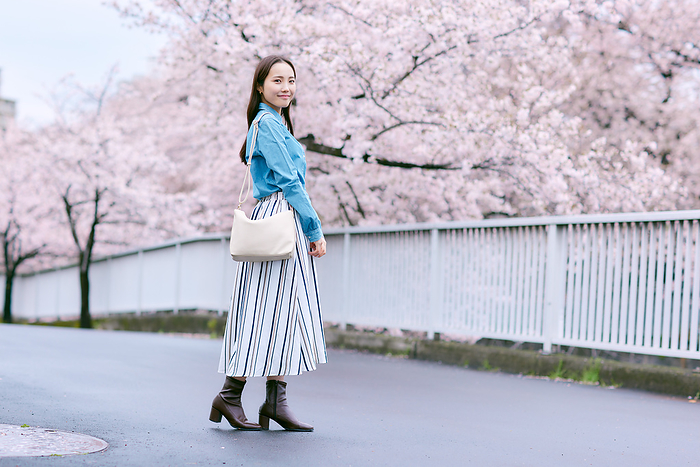 Cherry blossoms and a smiling Japanese woman