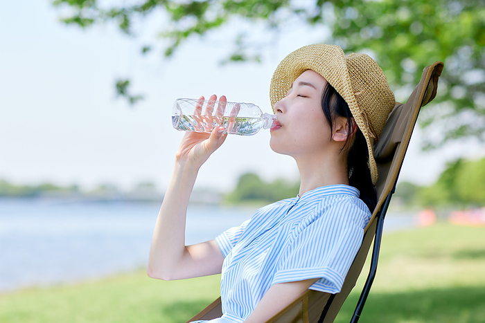 Japanese woman drinking fresh greenery and water