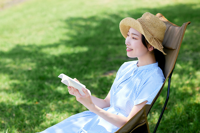 Japanese woman reading outdoors