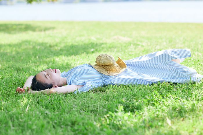 Japanese woman relaxing on the lawn