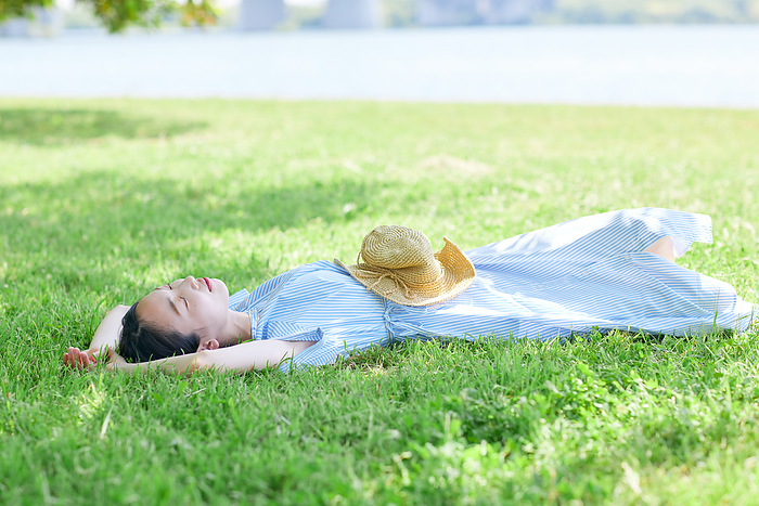 Japanese woman dozing on the lawn