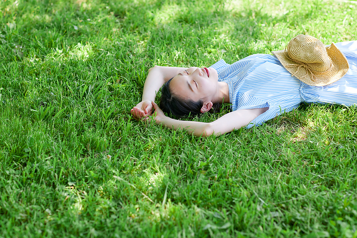 Japanese woman dozing on the lawn