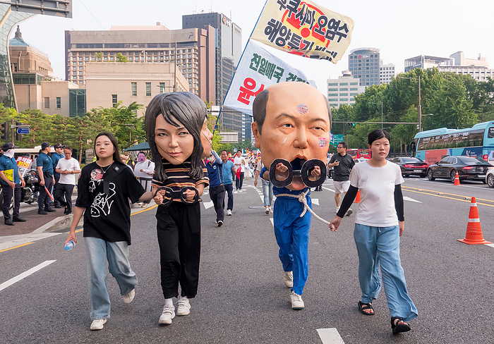 Rally calling for South Korean President Yoon Suk Yeol to prepare measures to stop Japan s decision to discharge radioactive water into the sea Anti Japan and anti Yoon Suk Yeol protest, June 24, 2023 : A protester  2nd R  wearing a mask satirizing South Korean President Yoon Suk Yeol as a criminal and another protester  2nd L  wearing a mask featuring facial plastic surgery of South Korean first lady Kim Keon Hee and satirizing her as another criminal, participate in an anti Japan and anti Yoon Suk Yeol protest march in central Seoul, South Korea. Thousands of protesters at the rally condemned South Korean President Yoon for being a pro Japanese autocrat and called for him to prepare measures to stop Japan s decision to discharge radioactive water from the crippled Fukushima nuclear power plant into the Pacific Ocean.  Photo by Lee Jae Won AFLO   SOUTH KOREA 