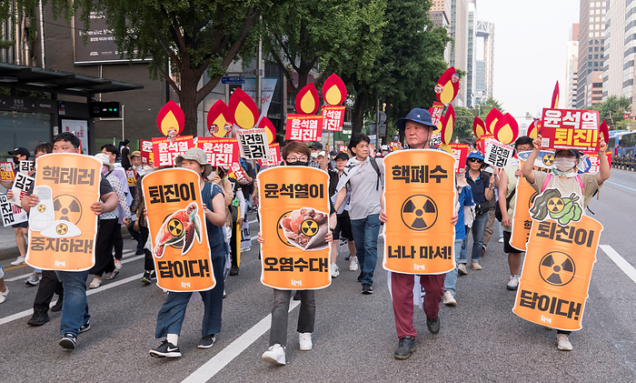 Rally calling for South Korean President Yoon Suk Yeol to prepare measures to stop Japan s decision to discharge radioactive water into the sea Anti Japan and anti Yoon Suk Yeol protest, June 24, 2023 : People march during an anti Japan and anti Yoon Suk Yeol protest in central Seoul, South Korea. Thousands of protesters at the rally condemned South Korean President Yoon for being a pro Japanese autocrat and called for him to prepare measures to stop Japan s decision to discharge radioactive water from the crippled Fukushima nuclear power plant into the Pacific Ocean. Korean characters read  L R, front ,  Stop nuclear terrorism  ,   Yoon s  Resignation is the solution  ,  Yoon Suk Yeol is radioactive water  ,   Yoon Suk Yeol  You drink nuclear waste water   and   Yoon s  Resignation is the solution  . Other pickets read,  Yoon Suk Yeol step down  .  Photo by Lee Jae Won AFLO   SOUTH KOREA 