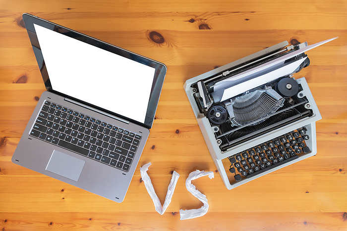 Old typewriter vs new laptop on the table. Concept of technology progress. Old typewriter vs new laptop on the table. Concept of technology progress., by Zoonar DAVID HERRAEZ