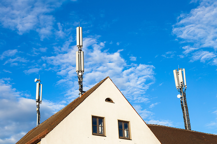 Mobile phone masts on a house roof in Germany Mobile phone masts on a house roof in Germany