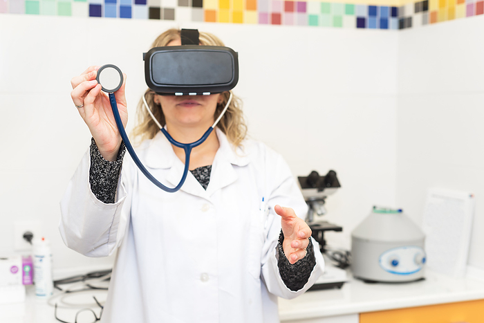 Female doctor wearing virtual reality glasses.Medical technology concept Female doctor wearing virtual reality glasses.Medical technology concept