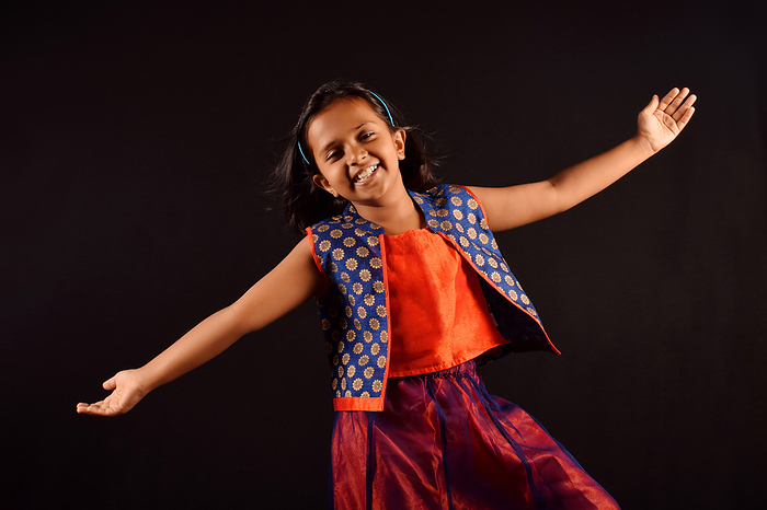 Little Girl in Indian attire with cute smile and outstretched arms posing in front of camera. Pune, Maharashtra Little Girl in Indian attire with cute smile and outstretched arms posing in front of camera. Pune, Maharashtra
