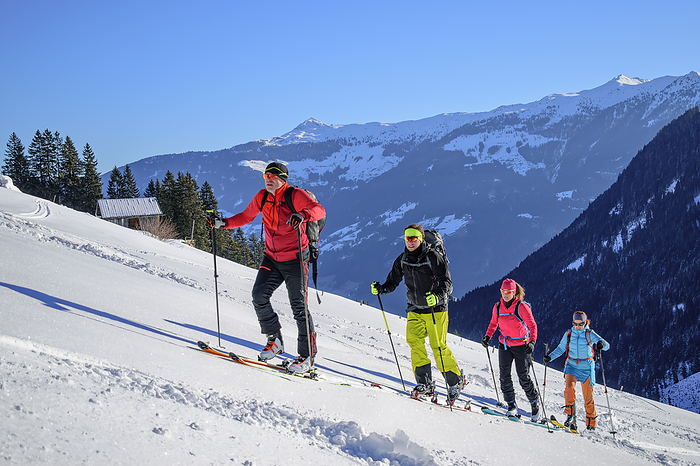 Austria, Tyrol, Group of skiers ascending snowcapped slope of Kellerjoch mountain