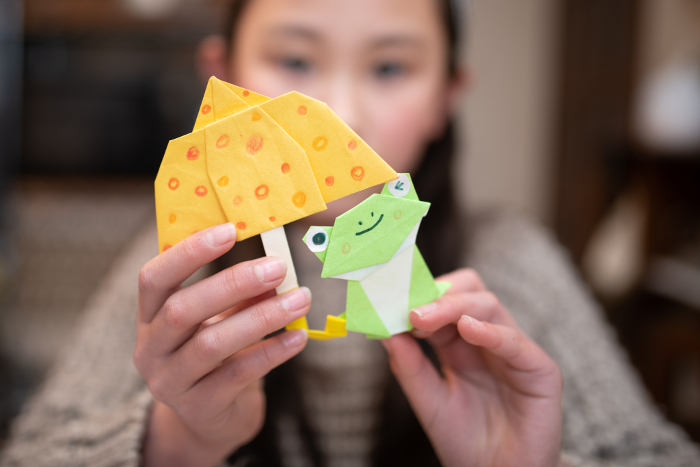Child with origami frog