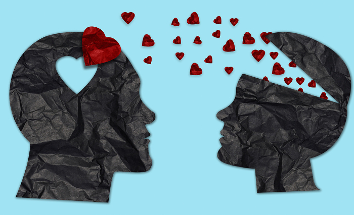 Paper silhouettes of man and woman from crumpled black paper and red hearts, love concept Paper silhouettes of man and woman from crumpled black paper and red hearts, love concept