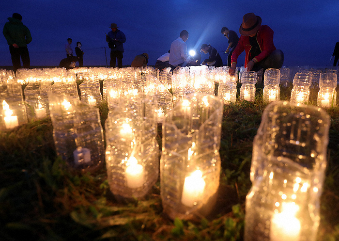 30 years since the Hokkaido Southwest Offshore Earthquake PET bottle lanterns lit in front of a cenotaph in the Aonae district, Okushiri Town, Hokkaido, Japan, July 12, 2023, 7:44 p.m.  photo by Taichi Kaizuka.