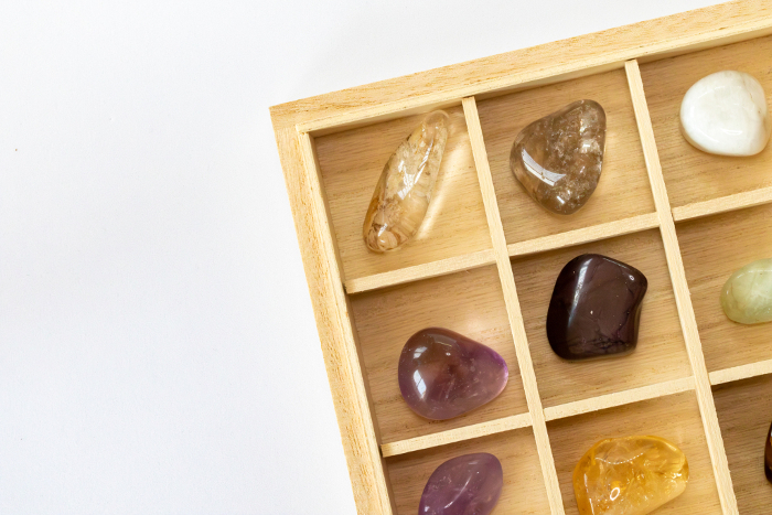 Power stones in specimen box, amethyst, citrine, aquamarine, smoky quartz, moonstone