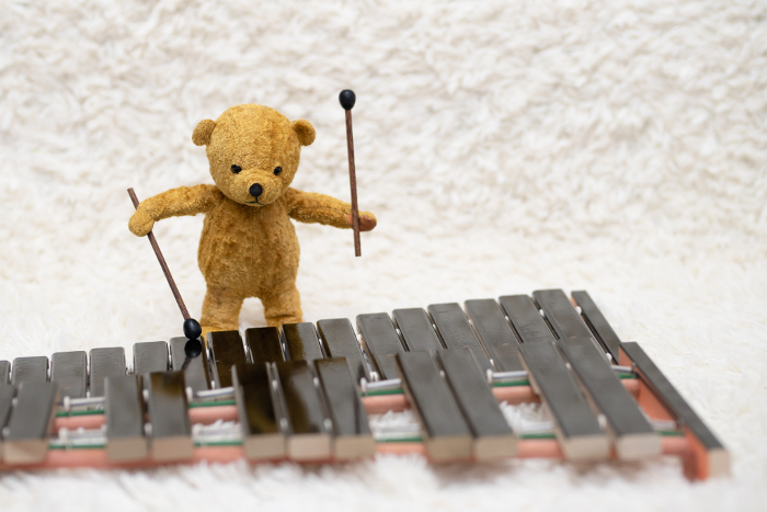 Bear playing xylophone in a sewing package
